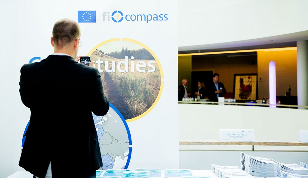 Event participant selecting fi-compass publications